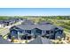 Expansive aerial shot featuring a neighborhood with well-maintained townhomes and green spaces at 157 Ambrose St, Erie, CO 80516