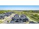 Wide aerial view of townhomes with grass and roads in background at 157 Ambrose St, Erie, CO 80516