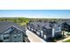 Aerial view of townhome community featuring solar panels, garages, and landscaped grounds at 157 Ambrose St, Erie, CO 80516