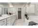 Bright bathroom with dual vanity, soaking tub, and separate shower at 157 Ambrose St, Erie, CO 80516