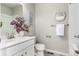 Bathroom with a white vanity, toilet, and framed mirror at 157 Ambrose St, Erie, CO 80516