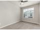 Neutral bedroom with a ceiling fan, large window, and carpeted floors at 157 Ambrose St, Erie, CO 80516