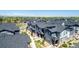 View of contemporary townhomes with gray siding, balconies, and sidewalks at 157 Ambrose St, Erie, CO 80516