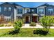 Charming townhome featuring a well-manicured lawn and inviting entryway with a covered porch at 157 Ambrose St, Erie, CO 80516