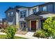 Attractive townhome showcasing a covered entry, stone accents, and neat landscaping at 157 Ambrose St, Erie, CO 80516