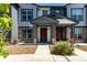 Exterior view of a townhome with a welcoming entrance and stone accents at 157 Ambrose St, Erie, CO 80516