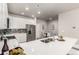 Bright modern kitchen with white cabinets and stainless steel appliances at 157 Ambrose St, Erie, CO 80516