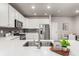 Clean kitchen with white cabinets, a stainless steel fridge and a dining area nearby at 157 Ambrose St, Erie, CO 80516