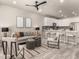 Living room featuring an open layout with a kitchen bar and modern decor at 157 Ambrose St, Erie, CO 80516