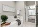 Relaxing main bathroom with a soaking tub, neutral tones, white tiling, and access to the main bedroom at 157 Ambrose St, Erie, CO 80516