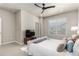 Comfortable main bedroom with a ceiling fan, soft carpeting, bright windows, and side tables with lamps at 157 Ambrose St, Erie, CO 80516