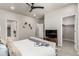 Open main bedroom layout with multiple doorways, neutral colors, soft carpeting, ceiling fan, and bright windows at 157 Ambrose St, Erie, CO 80516