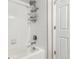 Clean white tiled shower with sleek fixtures and glass door at 157 Ambrose St, Erie, CO 80516