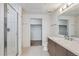 Clean bathroom features a walk-in shower, tiled floor, modern vanity, and an adjacent closet at 3500 S Corona St # 409, Englewood, CO 80113