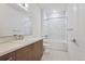 Bright bathroom features a tiled shower-tub, vanity with modern fixtures, and hexagon tile floors at 3500 S Corona St # 409, Englewood, CO 80113