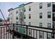 Modern apartment building featuring a large mural and private balcony with black metal railing at 3500 S Corona St # 409, Englewood, CO 80113