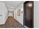 Apartment hallway with a carpeted floor, white walls, and black doors at 3500 S Corona St # 409, Englewood, CO 80113