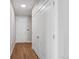 Hallway with hardwood floors, white walls, and closet doors, creating a clean, modern aesthetic at 3500 S Corona St # 409, Englewood, CO 80113