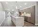 Stylish kitchen with a center island, stainless steel appliances, and light wood cabinetry in an open layout at 3500 S Corona St # 409, Englewood, CO 80113
