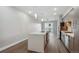 Modern kitchen features a large island, stainless steel appliances, sleek cabinetry, and wood floors at 3500 S Corona St # 409, Englewood, CO 80113