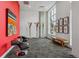 Apartment lobby featuring a bold red wall, modern seating, a unique light fixture, and a large window at 3500 S Corona St # 409, Englewood, CO 80113