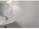 Bathroom featuring a pedestal sink and a round mirror at 4152 Netherland St, Denver, CO 80249