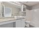 Bathroom featuring granite countertops, large mirror, white cabinets, and combined shower and tub at 4152 Netherland St, Denver, CO 80249