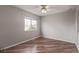 Bedroom featuring a ceiling fan, a window letting in natural light, and laminate wood flooring at 4152 Netherland St, Denver, CO 80249