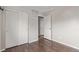 A bedroom featuring laminate wood flooring, closet with bi-fold doors, and access to a second room at 4152 Netherland St, Denver, CO 80249