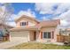 Charming two-story home with a well-manicured front yard and attached two-car garage at 4152 Netherland St, Denver, CO 80249