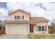 Charming two-story home with a well-manicured front yard and attached two-car garage at 4152 Netherland St, Denver, CO 80249