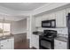 Kitchen featuring black appliances and granite countertops at 4152 Netherland St, Denver, CO 80249