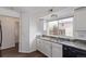 Bright kitchen featuring white cabinets and granite countertops at 4152 Netherland St, Denver, CO 80249