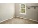 Bedroom featuring carpet flooring, neutral paint, a window, and built-in shelves at 8265 W 90Th Pl, Broomfield, CO 80021