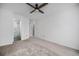 Bedroom featuring carpet floors, a ceiling fan, and an ensuite bathroom at 8265 W 90Th Pl, Broomfield, CO 80021