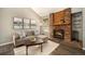 Cozy living room featuring a brick fireplace, comfortable seating, and stylish decor at 8265 W 90Th Pl, Broomfield, CO 80021