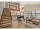 Open concept living room featuring a staircase, loft, and modern decor at 8265 W 90Th Pl, Broomfield, CO 80021