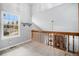 Open loft area overlooking the living room with natural light from a large window at 8265 W 90Th Pl, Broomfield, CO 80021