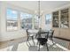 Bright breakfast nook features a round table and chairs, offering a view of the backyard at 1268 Limestone Dr, Erie, CO 80516