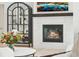 Modern fireplace with a light stone surround and a black mantel at 1268 Limestone Dr, Erie, CO 80516