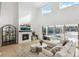 Bright and airy living room with a modern fireplace and view of backyard at 1268 Limestone Dr, Erie, CO 80516