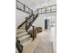 Modern staircase with dark wood and cable railing, leading to the second floor at 1268 Limestone Dr, Erie, CO 80516