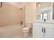 Bright bathroom featuring a shower-tub, toilet, and white vanity at 8648 Carneros Ct, Parker, CO 80138