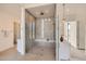 Modern bathroom with large glass shower, tile floors, and built-in seat at 8648 Carneros Ct, Parker, CO 80138