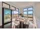 Bright dining room with floor to ceiling windows and modern table with seating for six at 8648 Carneros Ct, Parker, CO 80138