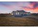 Beautiful modern home with a 2-car garage viewed at sunset at 8648 Carneros Ct, Parker, CO 80138