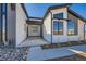 Modern home with covered front porch, large windows, and low-maintenance yard at 8648 Carneros Ct, Parker, CO 80138
