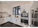 Well-appointed kitchen featuring white cabinetry, subway tile backsplash, stainless steel appliances, and modern black hardware at 8648 Carneros Ct, Parker, CO 80138