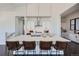 Bright kitchen with large center island, quartz countertops, stainless steel appliances, and dark wood flooring at 8648 Carneros Ct, Parker, CO 80138
