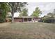 Expansive backyard with brick home, back patio, mature tree, and partial fence for privacy at 2251 Braun Dr, Golden, CO 80401